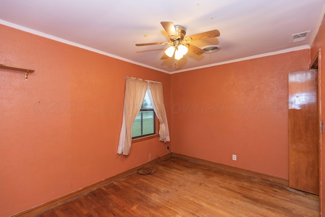507 Aaron Rd, Fritch, TX 79036 - spare room with crown molding, a ceiling fan, visible vents, and wood finished floors
