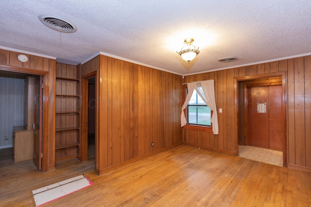 507 Aaron Rd, Fritch, TX 79036 - interior space featuring ornamental molding, a textured ceiling, hardwood / wood-style floors, and visible vents