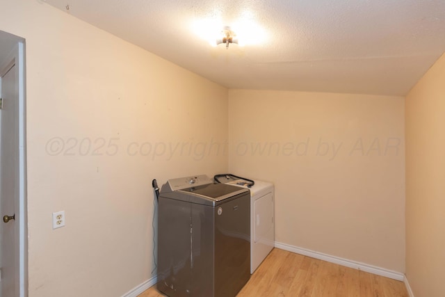 507 Aaron Rd, Fritch, TX 79036 - laundry room featuring baseboards, light wood-style floors, washing machine and dryer, and laundry area