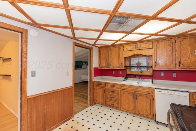 507 Aaron Rd, Fritch, TX 79036 - kitchen featuring light countertops, brown cabinetry, white dishwasher, and a sink