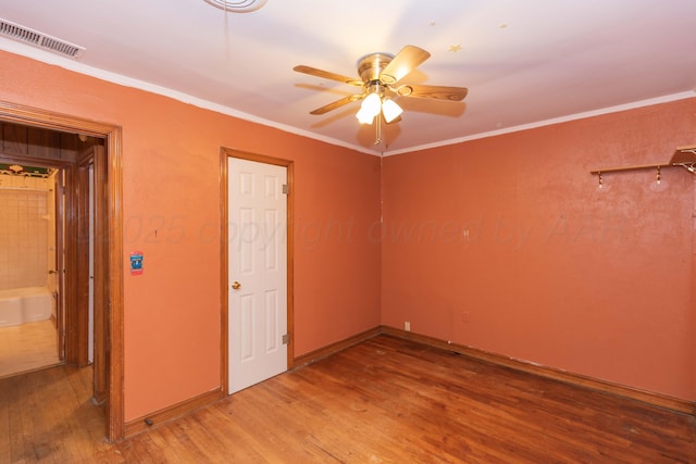 507 Aaron Rd, Fritch, TX 79036 - spare room featuring a ceiling fan, light wood-style flooring, baseboards, visible vents, and crown molding