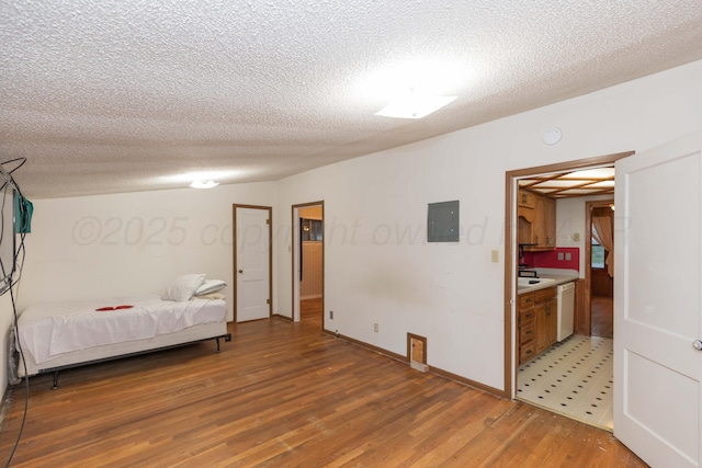507 Aaron Rd, Fritch, TX 79036 - bedroom featuring light wood finished floors, a textured ceiling, baseboards, and ensuite bathroom