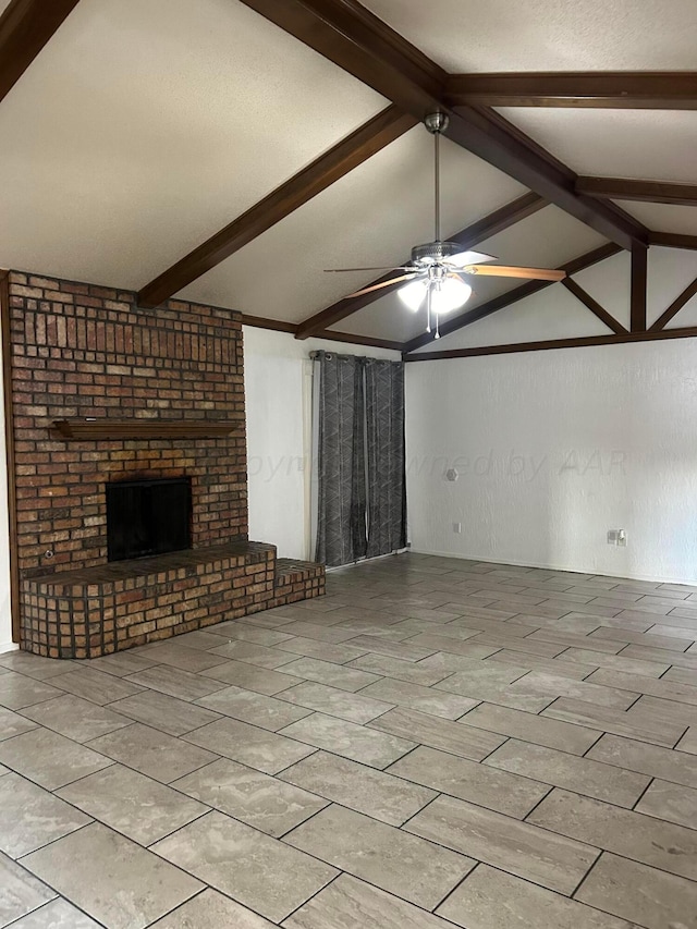 unfurnished living room with ceiling fan, a brick fireplace, vaulted ceiling with beams, and a textured ceiling