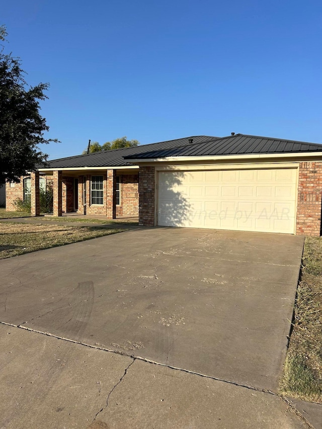 view of front of house with concrete driveway, a garage, and brick siding