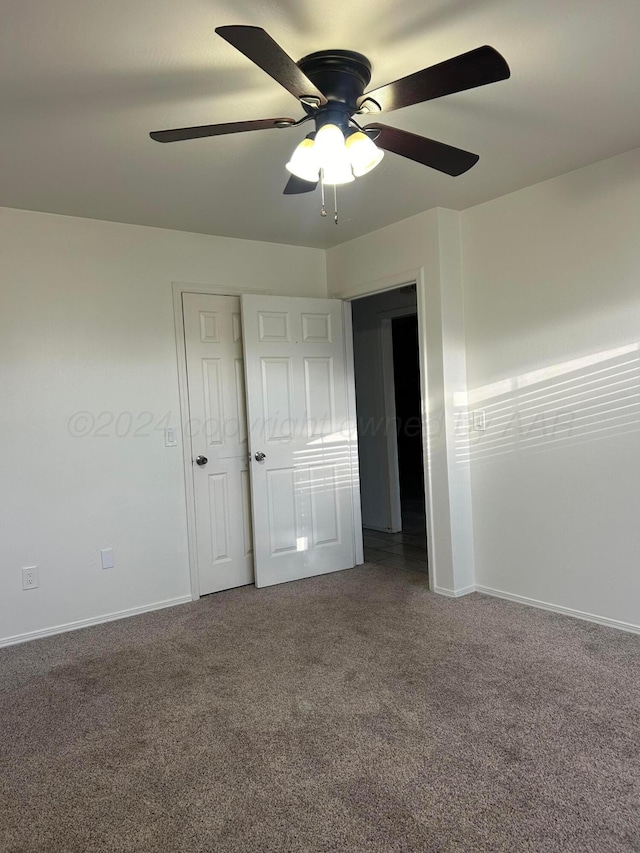 unfurnished bedroom with baseboards, carpet, and a ceiling fan