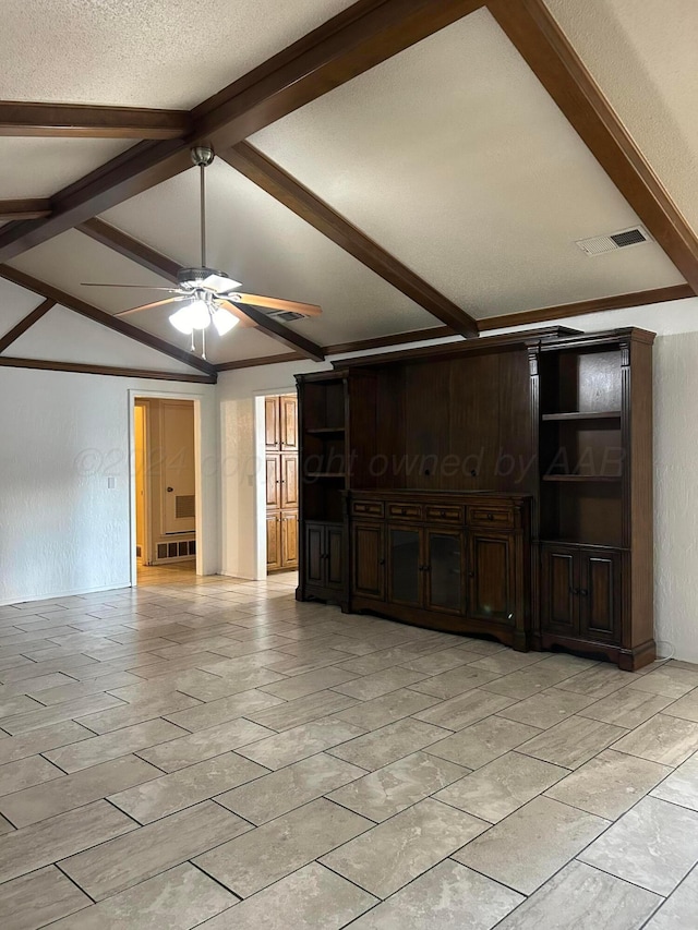 unfurnished living room with lofted ceiling with beams, a textured wall, visible vents, and ceiling fan