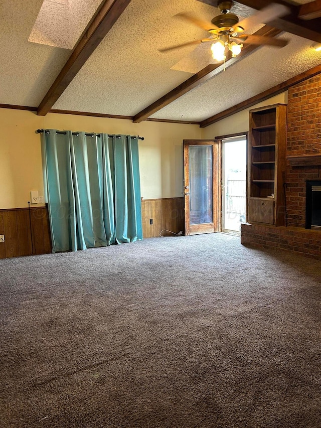 2914 Detroit St, Amarillo, TX 79103 - unfurnished living room featuring a textured ceiling, wainscoting, wood walls, carpet, and a ceiling fan