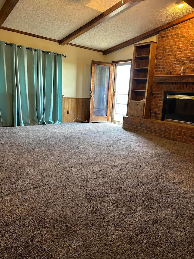 2914 Detroit St, Amarillo, TX 79103 - unfurnished living room with a textured ceiling, a wainscoted wall, carpet floors, a fireplace, and wooden walls