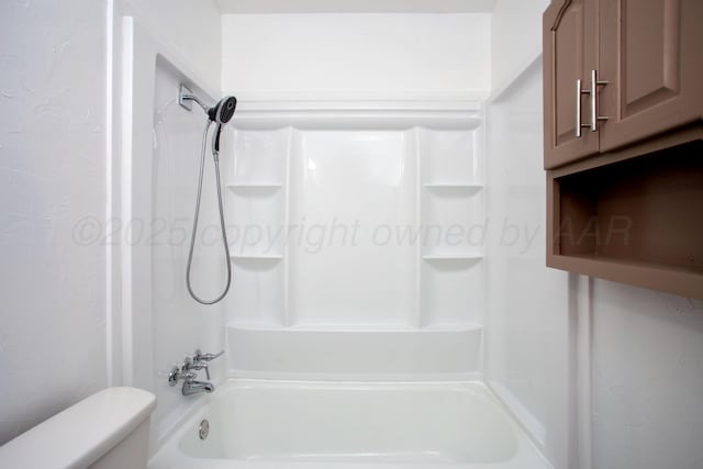 bathroom with washtub / shower combination and toilet