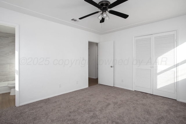 unfurnished bedroom featuring carpet floors, a closet, ceiling fan, and ensuite bathroom