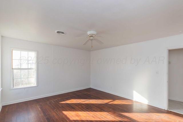 empty room with dark hardwood / wood-style flooring and ceiling fan