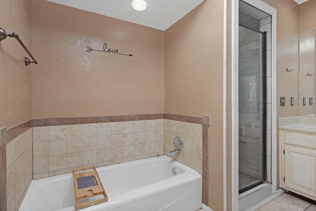 full bathroom featuring vanity, a garden tub, and a stall shower