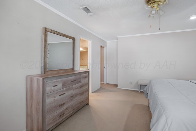 bedroom featuring visible vents, crown molding, light colored carpet, baseboards, and ensuite bath