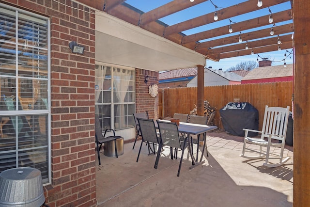 view of patio featuring fence, a pergola, outdoor dining area, and grilling area