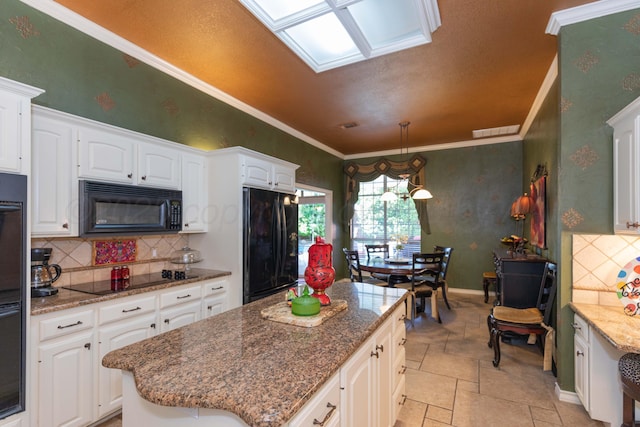 7821 Covington Pkwy, Amarillo, TX 79121 - kitchen featuring black appliances, white cabinets, a kitchen island, decorative backsplash, and dark stone counters