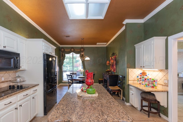 7821 Covington Pkwy, Amarillo, TX 79121 - kitchen featuring black appliances, white cabinetry, decorative backsplash, light stone countertops, and crown molding