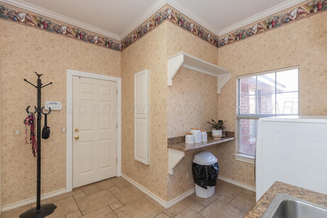 7821 Covington Pkwy, Amarillo, TX 79121 - foyer entrance featuring ornamental molding, baseboards, wallpapered walls, and washer / clothes dryer
