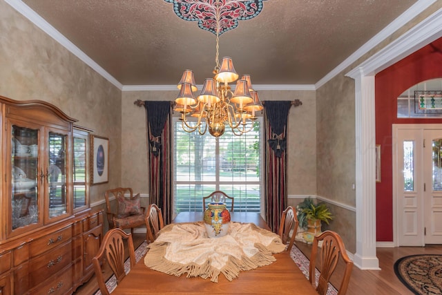 7821 Covington Pkwy, Amarillo, TX 79121 - dining room featuring a chandelier, wood finished floors, ornamental molding, and a textured ceiling