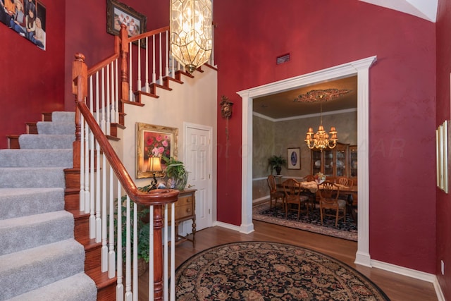 7821 Covington Pkwy, Amarillo, TX 79121 - foyer with a chandelier, wood finished floors, stairway, baseboards, and a high ceiling
