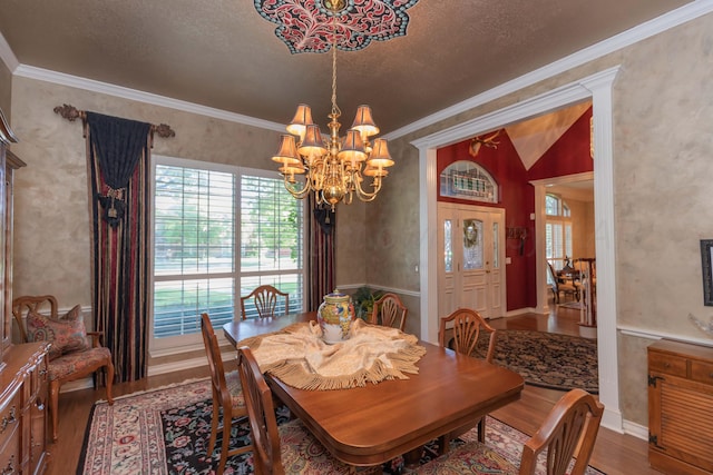 7821 Covington Pkwy, Amarillo, TX 79121 - dining area featuring wood finished floors, a chandelier, healthy amount of natural light, ornamental molding, and a textured ceiling
