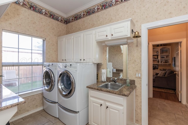 7821 Covington Pkwy, Amarillo, TX 79121 - laundry room with wallpapered walls, healthy amount of natural light, washer and clothes dryer, crown molding, and cabinet space