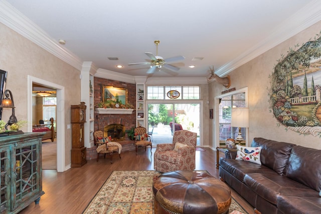 7821 Covington Pkwy, Amarillo, TX 79121 - living room with ceiling fan, wood finished floors, a large fireplace, crown molding, and baseboards