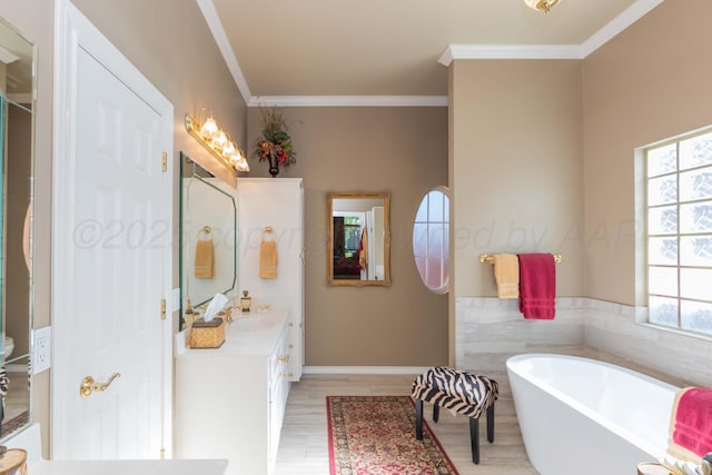7821 Covington Pkwy, Amarillo, TX 79121 - bathroom with a freestanding tub, vanity, wood finished floors, and ornamental molding