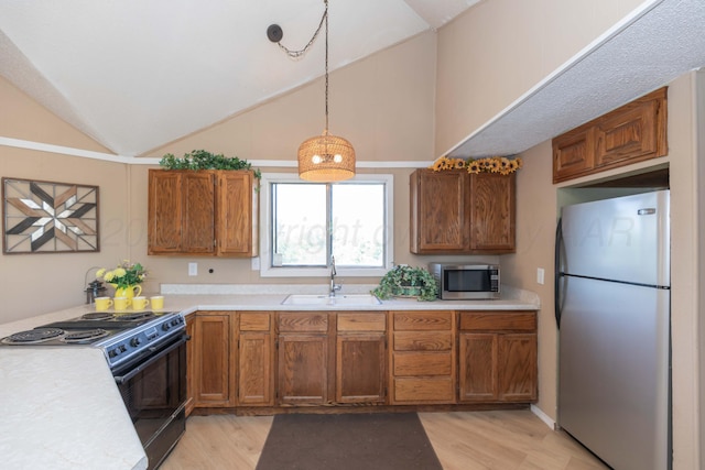 233 Doucette Dr, Howardwick, TX 79226 - kitchen with stainless steel appliances, light wood-style floors, light countertops, and vaulted ceiling