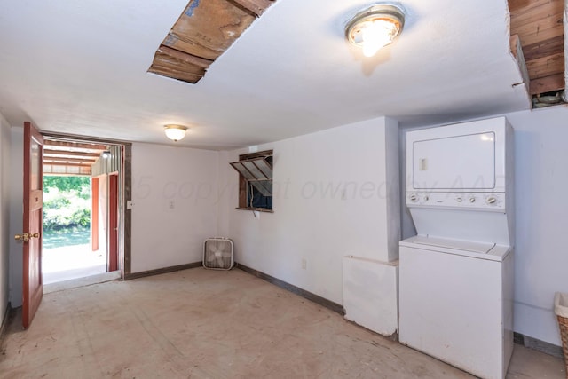 233 Doucette Dr, Howardwick, TX 79226 - below grade area featuring stacked washer / drying machine and baseboards