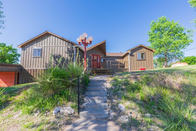 233 Doucette Dr, Howardwick, TX 79226 - view of front facade with board and batten siding, a wooden deck, and a garage