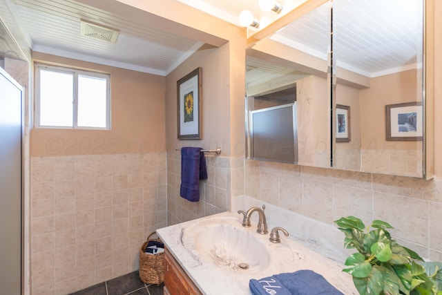 233 Doucette Dr, Howardwick, TX 79226 - bathroom with tile walls, vanity, a wainscoted wall, and ornamental molding