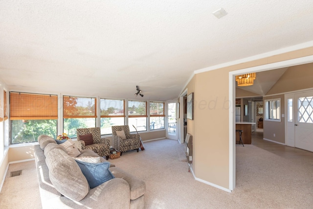 233 Doucette Dr, Howardwick, TX 79226 - carpeted living room with a textured ceiling and a chandelier