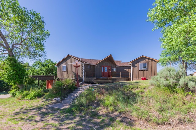 233 Doucette Dr, Howardwick, TX 79226 - back of house with board and batten siding, a wooden deck, and stairway