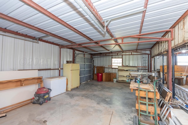 233 Doucette Dr, Howardwick, TX 79226 - garage featuring freestanding refrigerator and metal wall