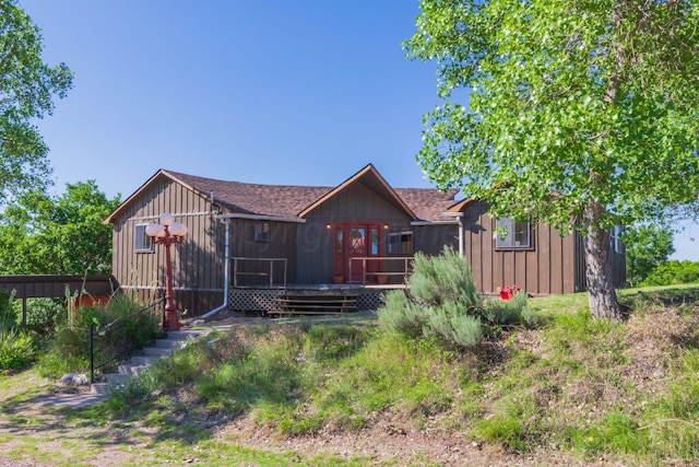 233 Doucette Dr, Howardwick, TX 79226 - rear view of property featuring a wooden deck, a shingled roof, and board and batten siding