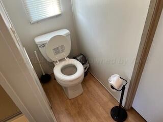 bathroom featuring wood-type flooring and toilet