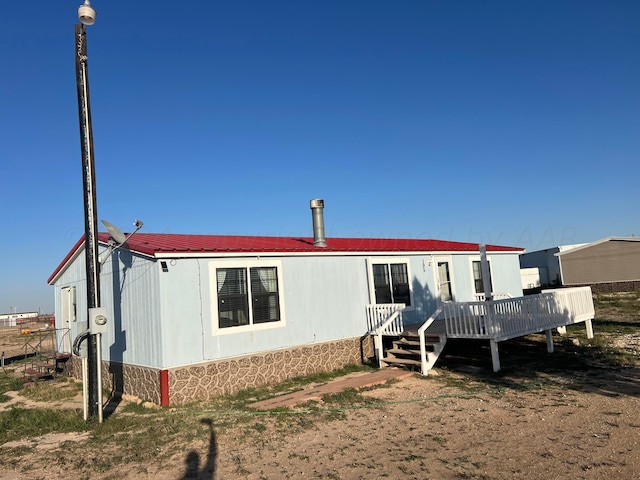 rear view of house featuring a deck