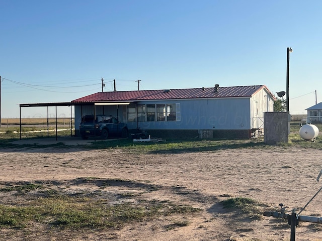 rear view of house with a carport