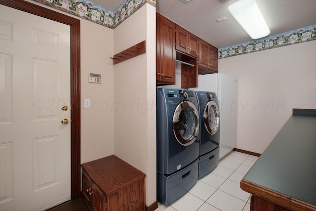 4502 Chesapeake Pl, Amarillo, TX 79119 - washroom with washer and clothes dryer, cabinet space, light tile patterned floors, and baseboards