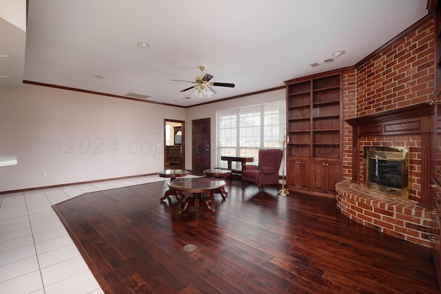 4502 Chesapeake Pl, Amarillo, TX 79119 - living room with a fireplace, ceiling fan, wood finished floors, crown molding, and baseboards