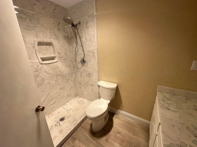 107 Galahad St, Borger, TX 79007 - bathroom featuring toilet, a shower stall, wood finished floors, and baseboards