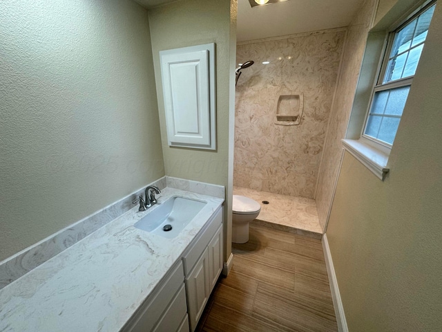 107 Galahad St, Borger, TX 79007 - full bath with toilet, a stall shower, vanity, baseboards, and a textured wall