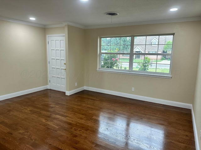 107 Galahad St, Borger, TX 79007 - spare room with healthy amount of natural light, dark wood-type flooring, crown molding, baseboards, and recessed lighting
