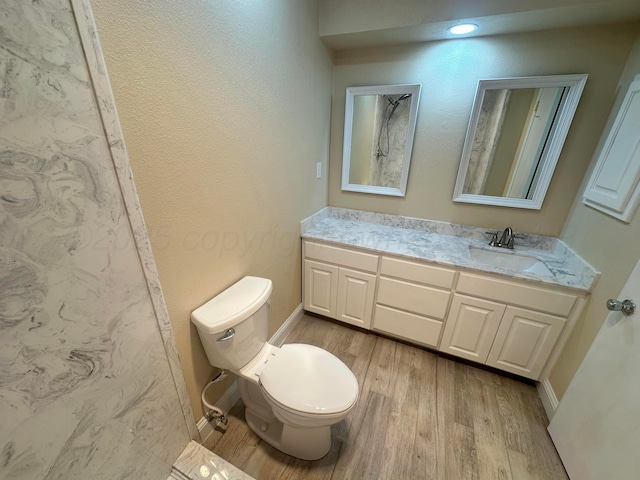 107 Galahad St, Borger, TX 79007 - bathroom with wood finished floors, toilet, vanity, and baseboards