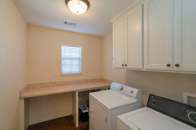 laundry area with washing machine and clothes dryer, visible vents, and cabinet space