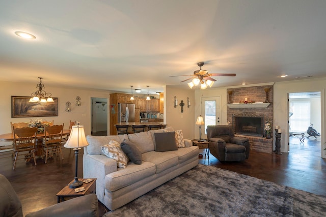 living room with visible vents, ceiling fan with notable chandelier, recessed lighting, crown molding, and a fireplace