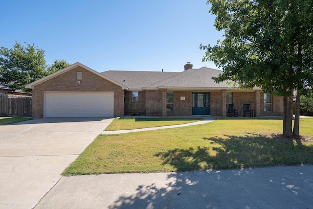 ranch-style house featuring brick siding, a garage, and a front lawn