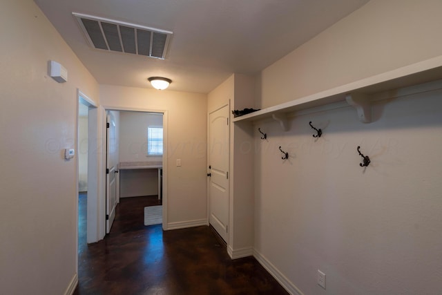 mudroom with visible vents, baseboards, and concrete floors