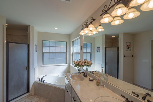 bathroom featuring a sink, a jetted tub, a shower stall, and double vanity