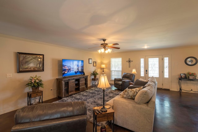 living room with baseboards, ornamental molding, and a ceiling fan